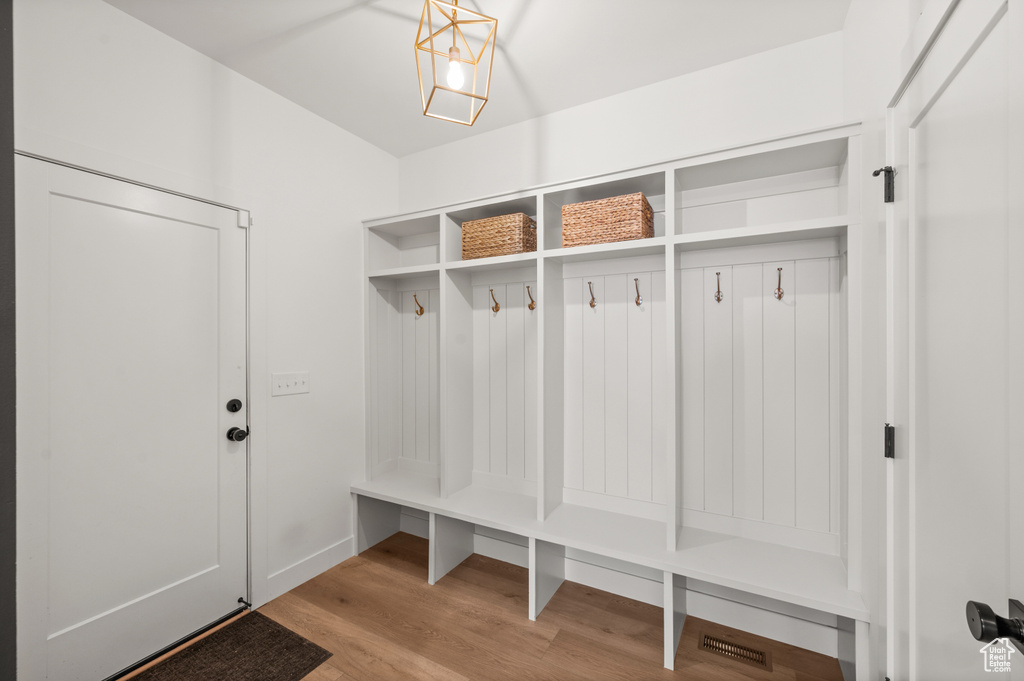 Mudroom featuring wood finished floors and baseboards