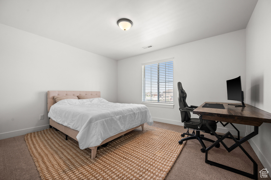 Bedroom featuring baseboards, carpet flooring, and an office area
