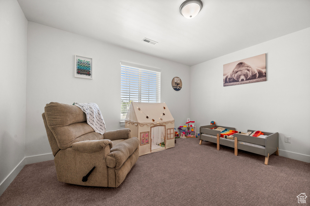Sitting room featuring carpet floors and baseboards