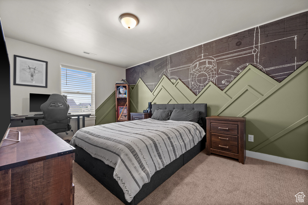 Bedroom featuring light colored carpet, a desk, and baseboards