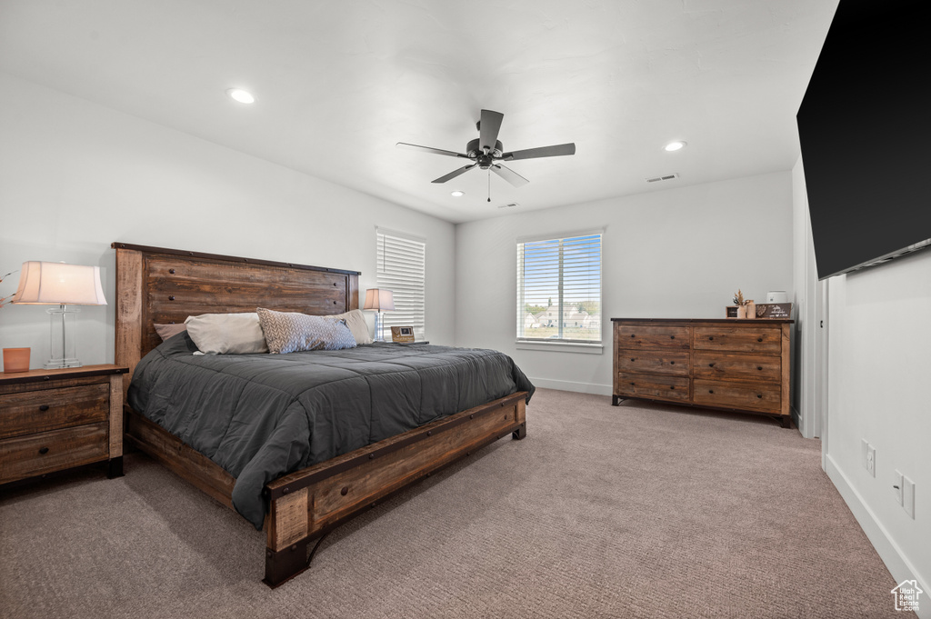 Carpeted bedroom featuring baseboards, recessed lighting, and ceiling fan