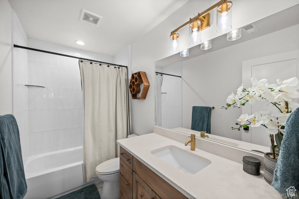 Full bath featuring toilet, vanity, and shower / tub combo with curtain
