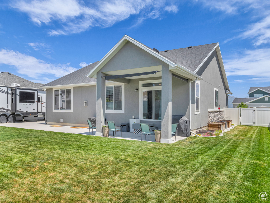 Rear view of property featuring stucco siding, a gate, a patio area, an outdoor living space, and a shingled roof