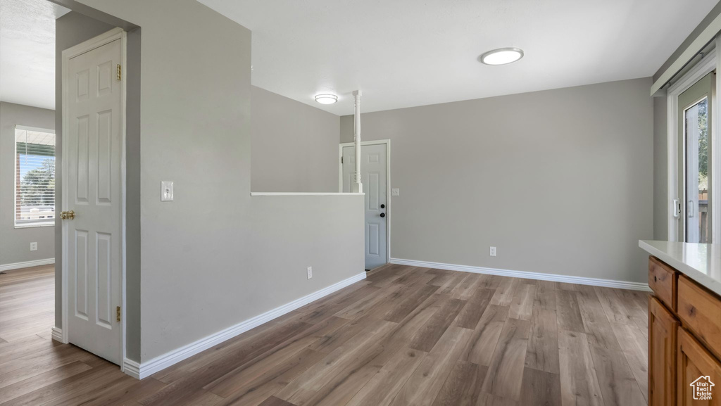 Unfurnished room featuring wood finished floors and baseboards