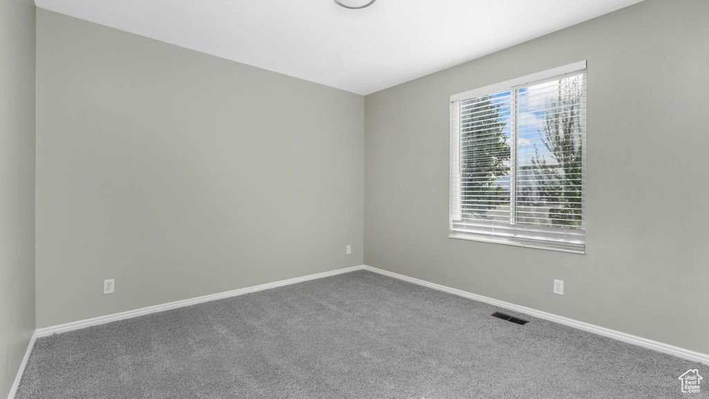 Unfurnished room with carpet floors and baseboards
