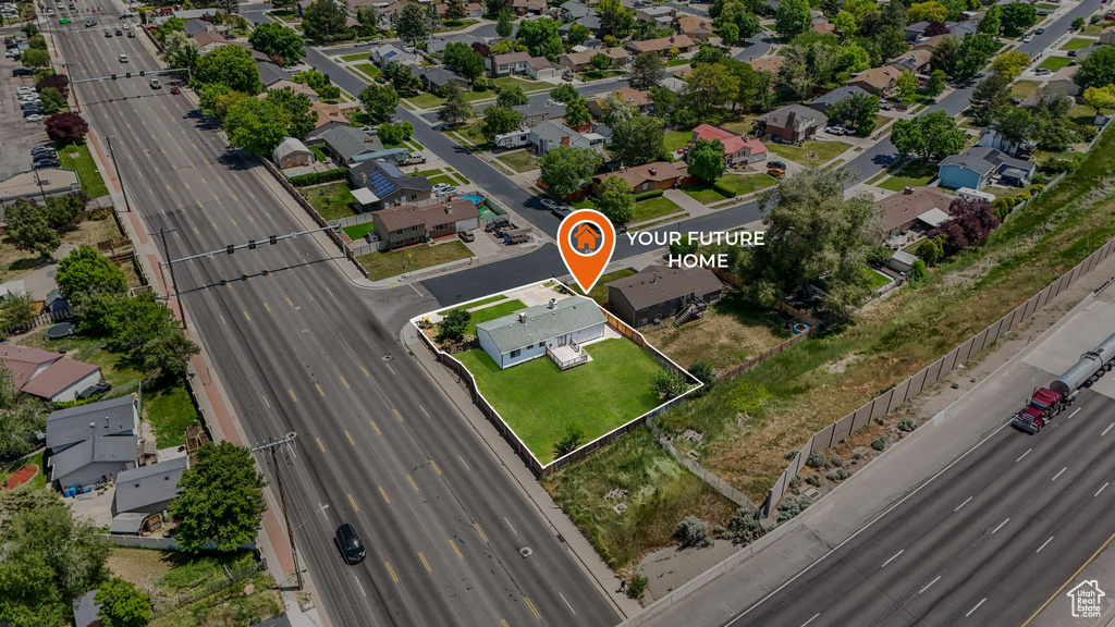 Aerial overview of property's location featuring a main thoroughfare and nearby suburban area