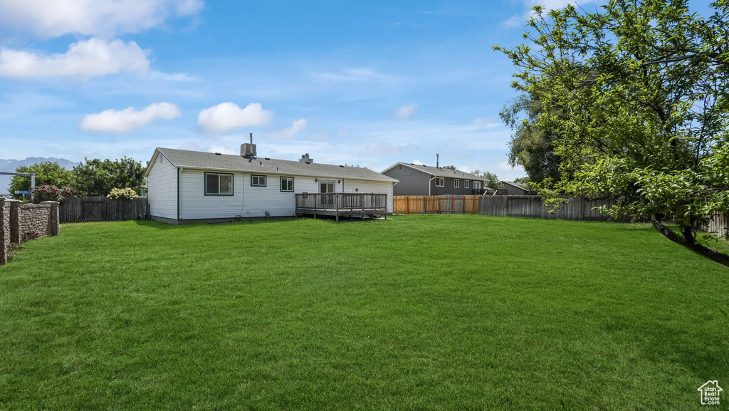 Rear view of property featuring a wooden deck