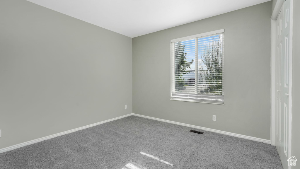 Empty room featuring carpet floors and baseboards