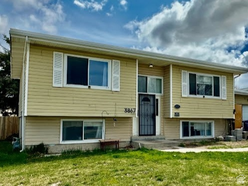 Bi-level home featuring a front lawn