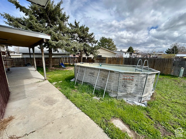 View of yard featuring a patio area and a playground
