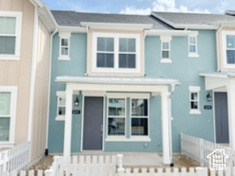 Multi unit property featuring a fenced front yard, a porch, and roof with shingles