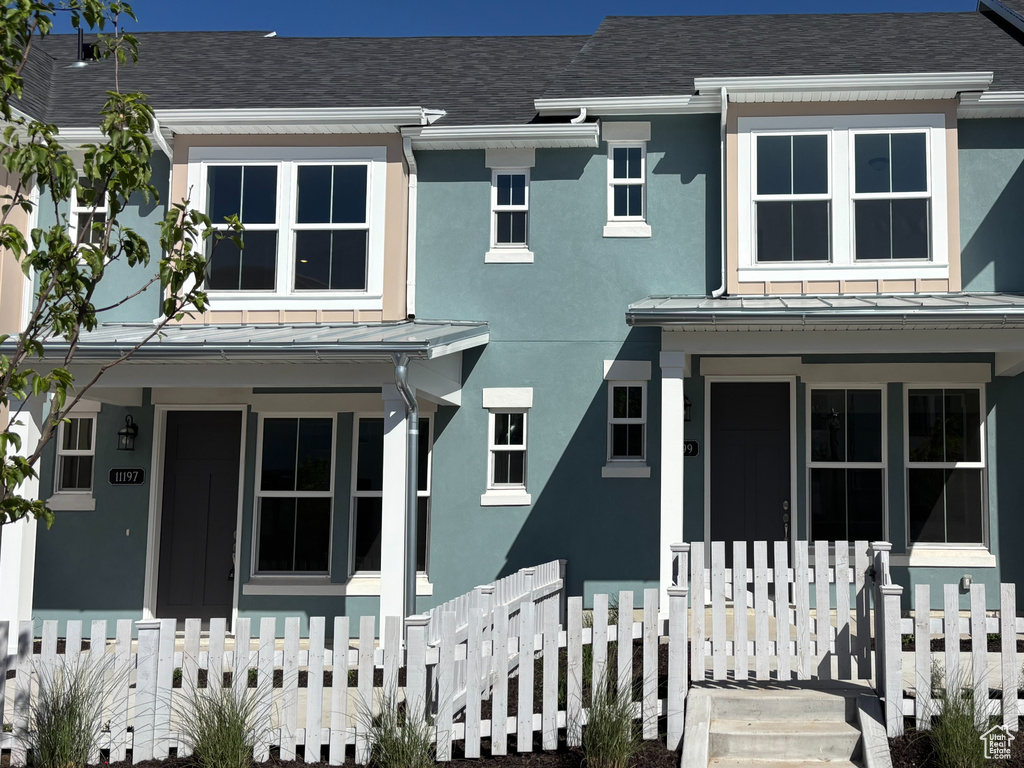 Townhome / multi-family property with a porch