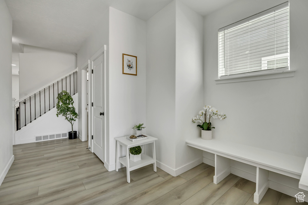 Mudroom featuring wood finished floors and baseboards