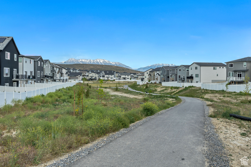 View of asphalt street with a residential view and a mountain view