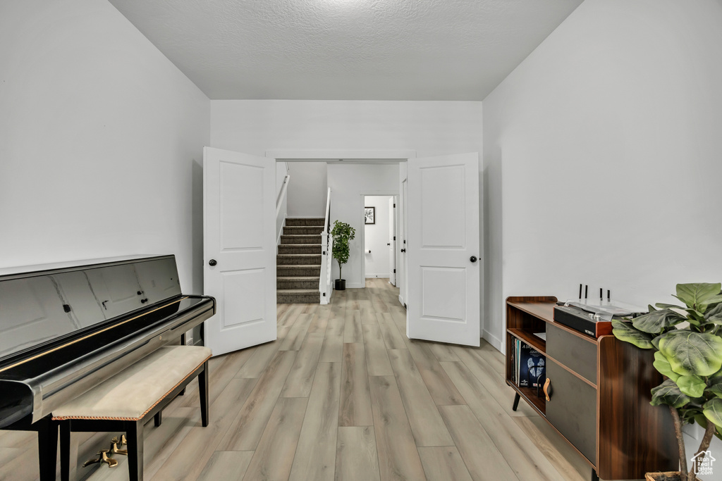 Living area featuring stairs and light wood finished floors