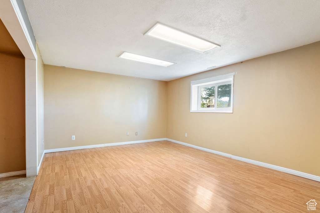 Empty room with light wood-style floors and baseboards