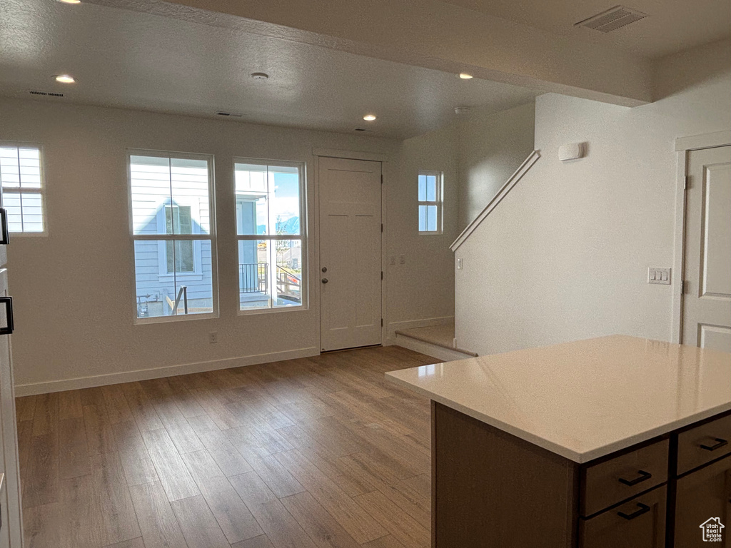 Foyer with plenty of natural light, baseboards, light wood-style flooring, and recessed lighting
