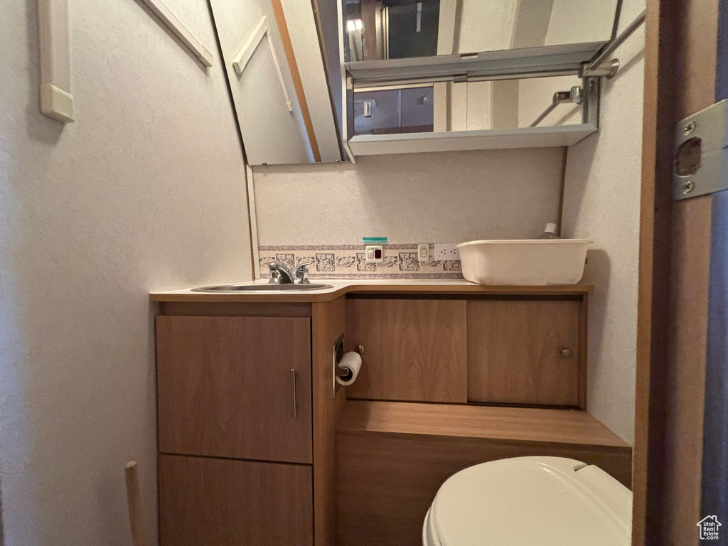 Bathroom featuring toilet and vanity