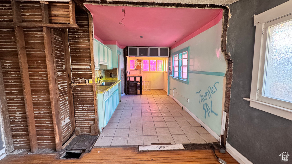 Kitchen with a sink and light tile patterned flooring