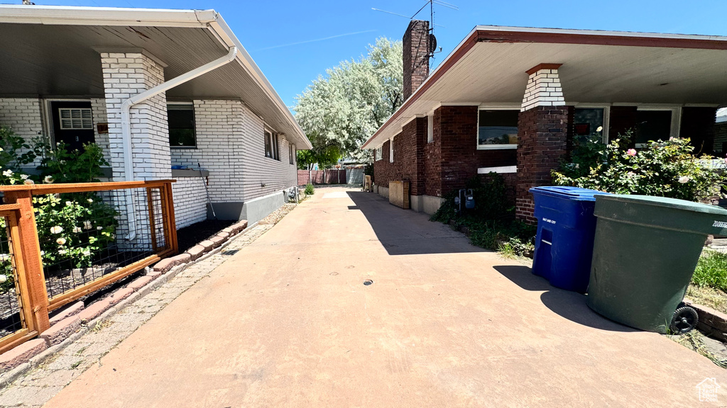 View of home's exterior featuring brick siding and a chimney