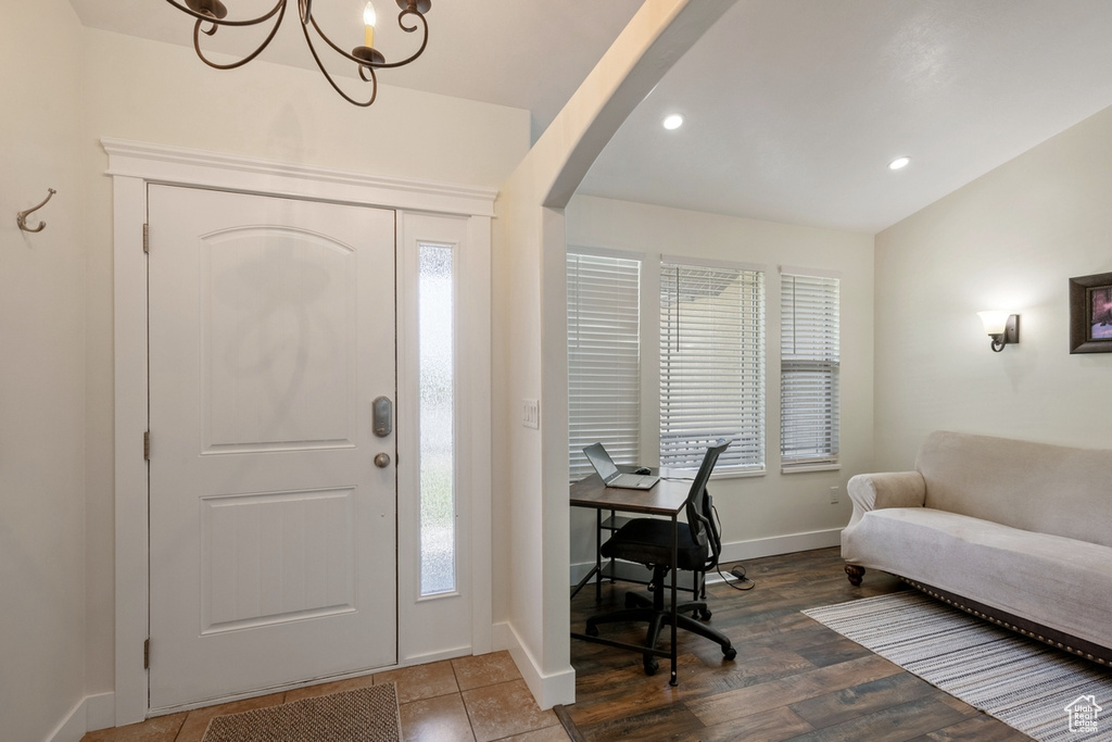 Entrance foyer featuring arched walkways, healthy amount of natural light, a chandelier, and recessed lighting