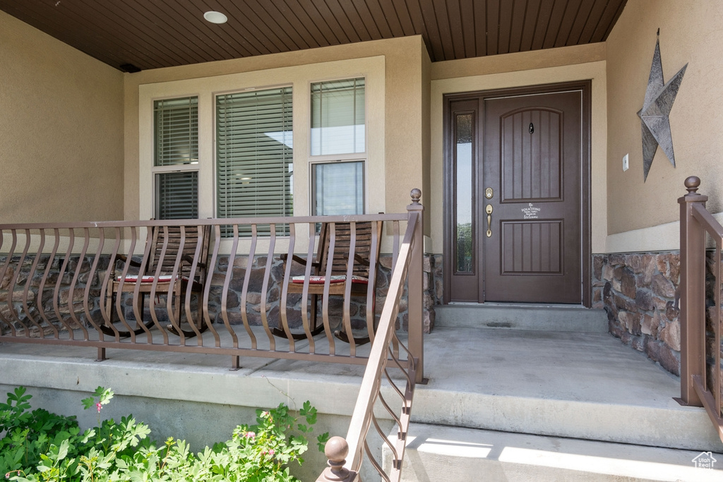 Property entrance featuring stucco siding