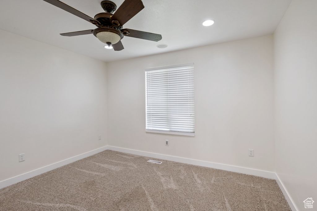 Empty room featuring light carpet, baseboards, a ceiling fan, and recessed lighting