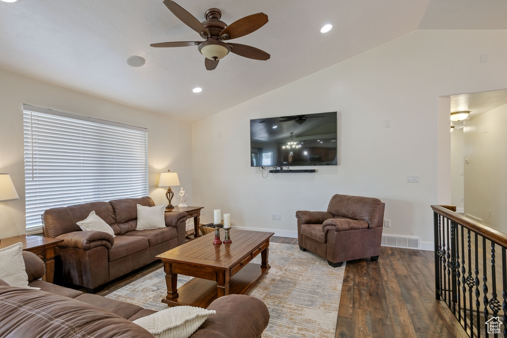 Living room with lofted ceiling, a ceiling fan, wood finished floors, recessed lighting, and baseboards