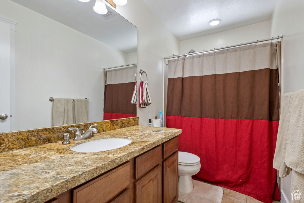 Full bathroom featuring vanity, toilet, tile patterned floors, and a shower with curtain