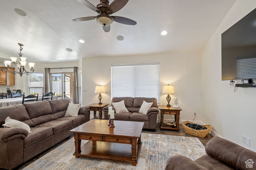 Living area featuring a ceiling fan, a chandelier, recessed lighting, wood finished floors, and baseboards