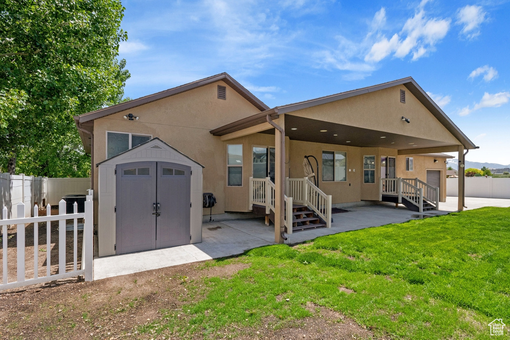 Back of house featuring stucco siding and a patio area
