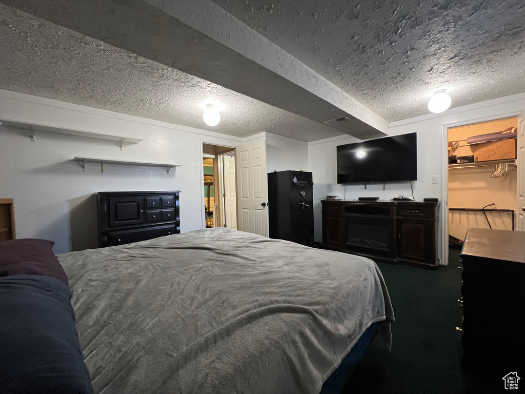 Carpeted bedroom featuring a textured ceiling