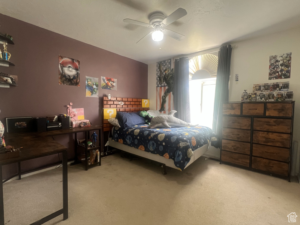 Bedroom with carpet floors and a ceiling fan