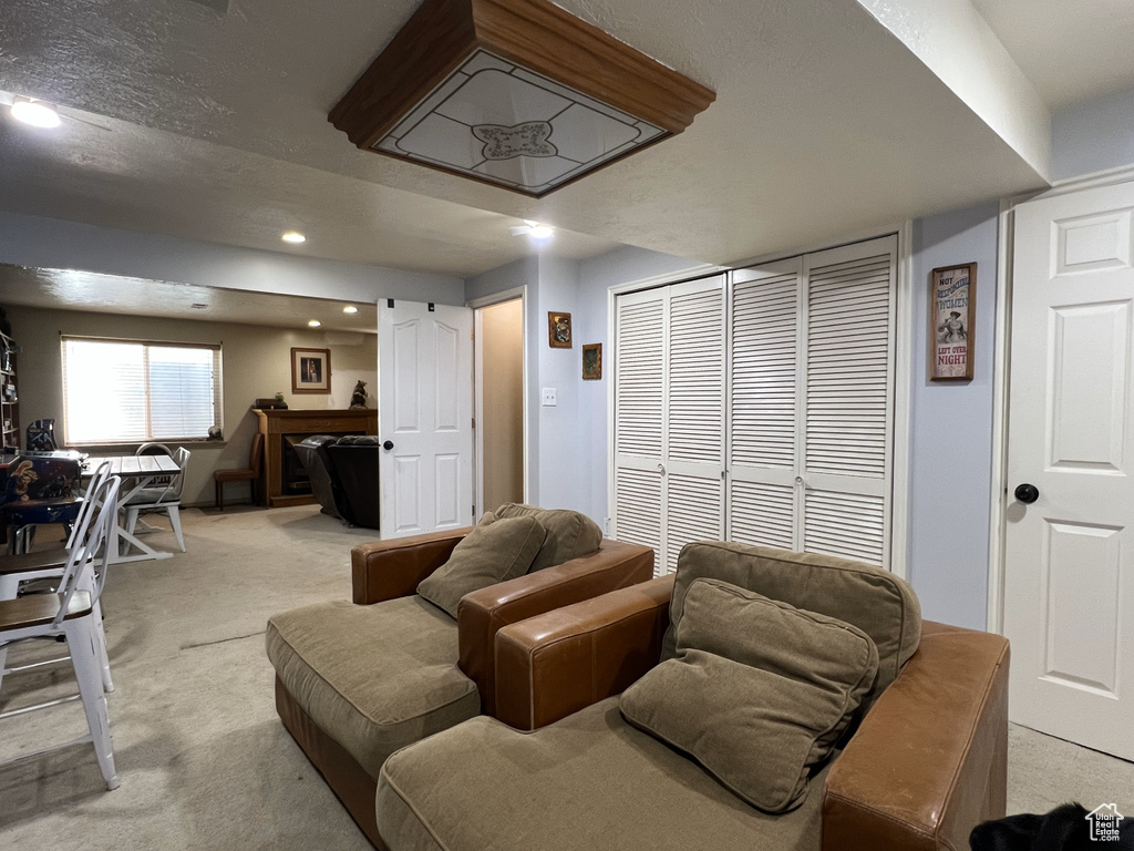 Living room featuring light colored carpet and recessed lighting