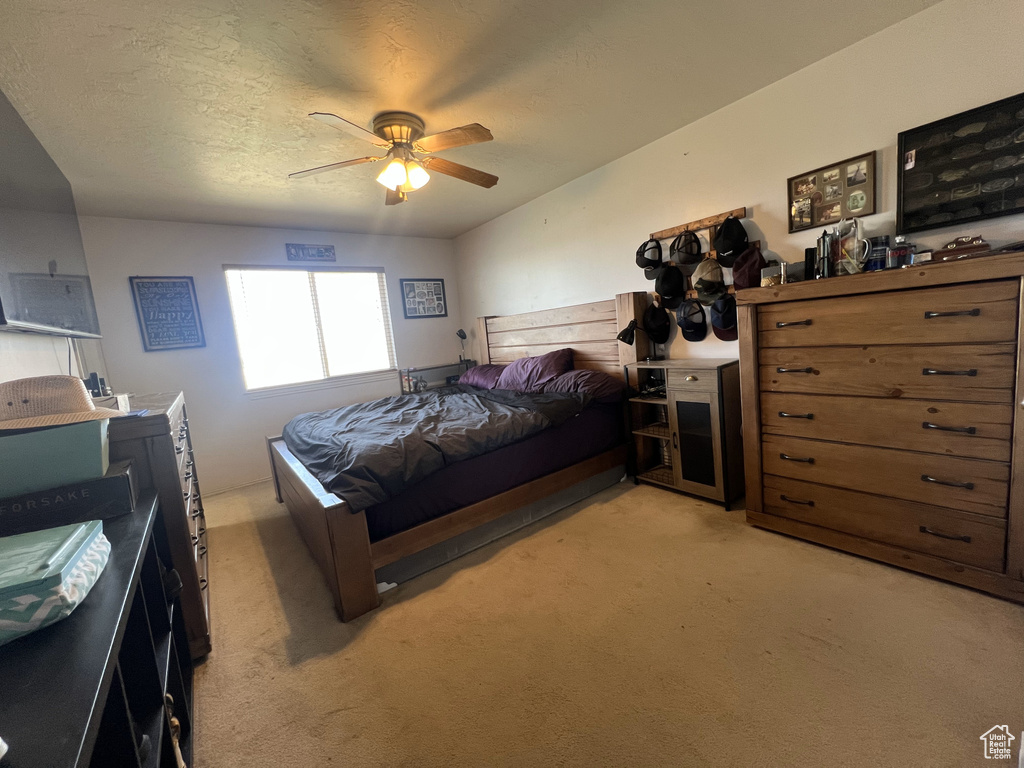Bedroom featuring light carpet and ceiling fan