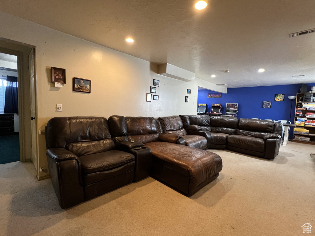 Living area featuring light carpet and recessed lighting