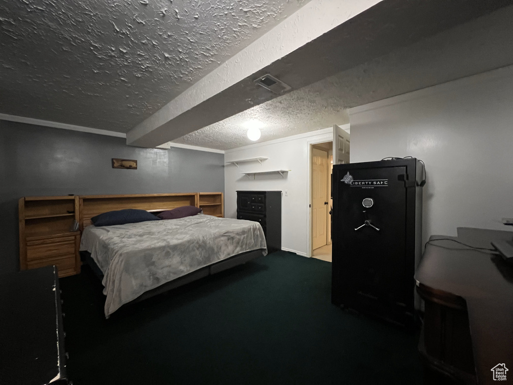 Carpeted bedroom featuring a textured ceiling