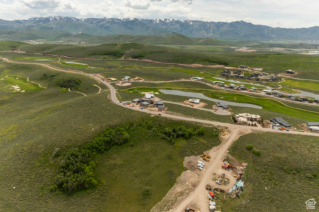 Aerial view of property and surrounding area with a water and mountain view