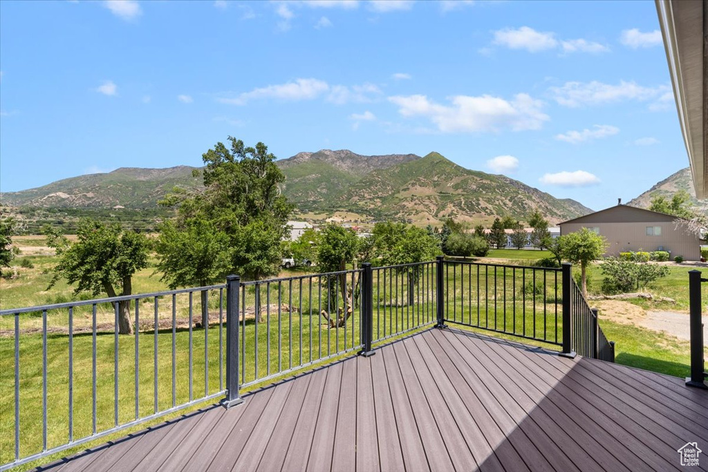 Wooden terrace with a mountain view and a yard