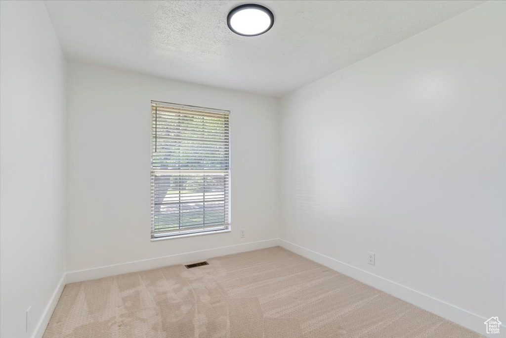Unfurnished room with baseboards and carpet flooring
