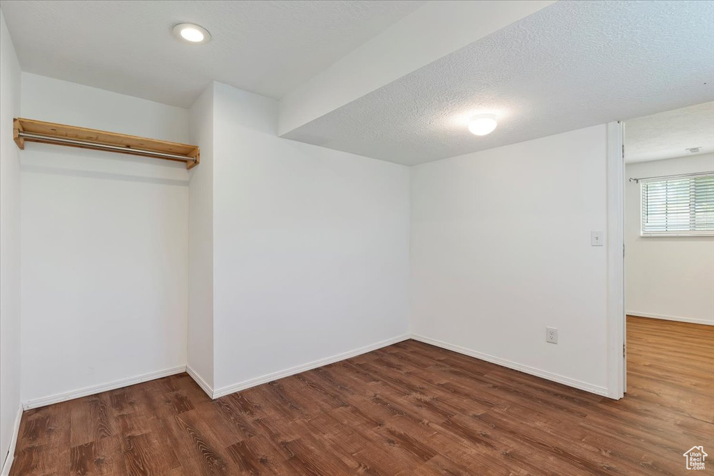 Basement with wood finished floors and baseboards
