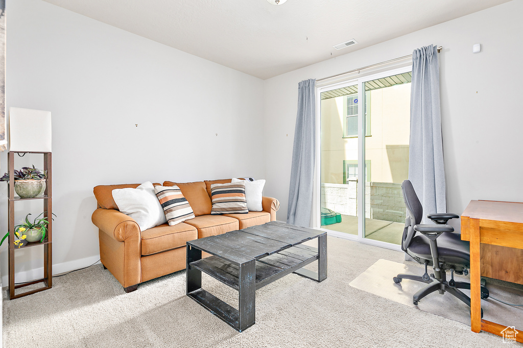 Home office with light carpet and baseboards