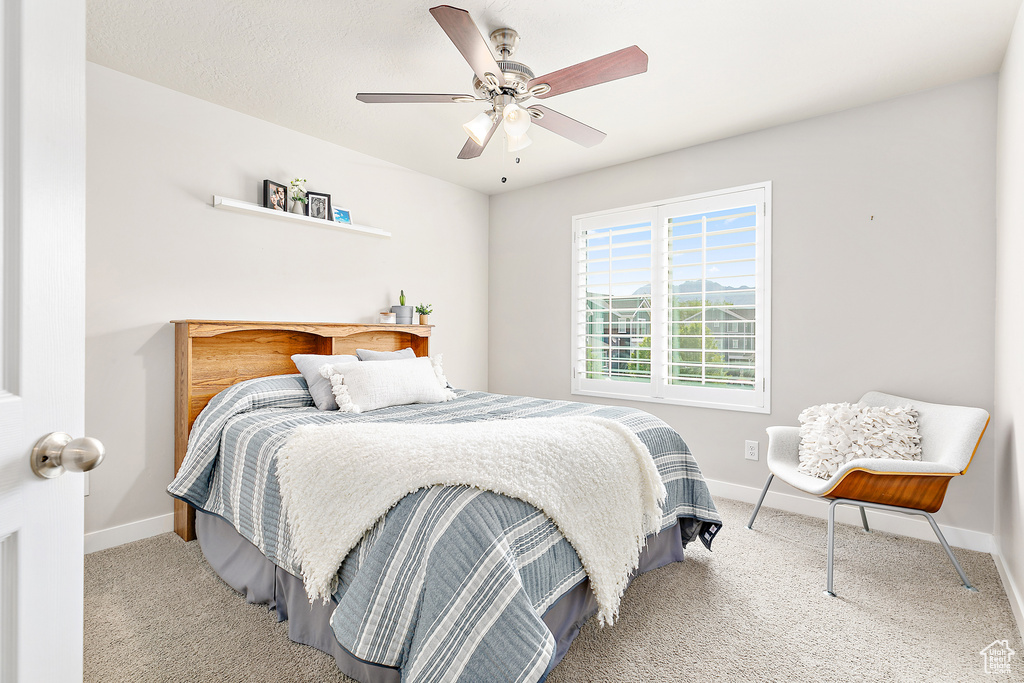 Bedroom featuring carpet flooring, baseboards, and a ceiling fan