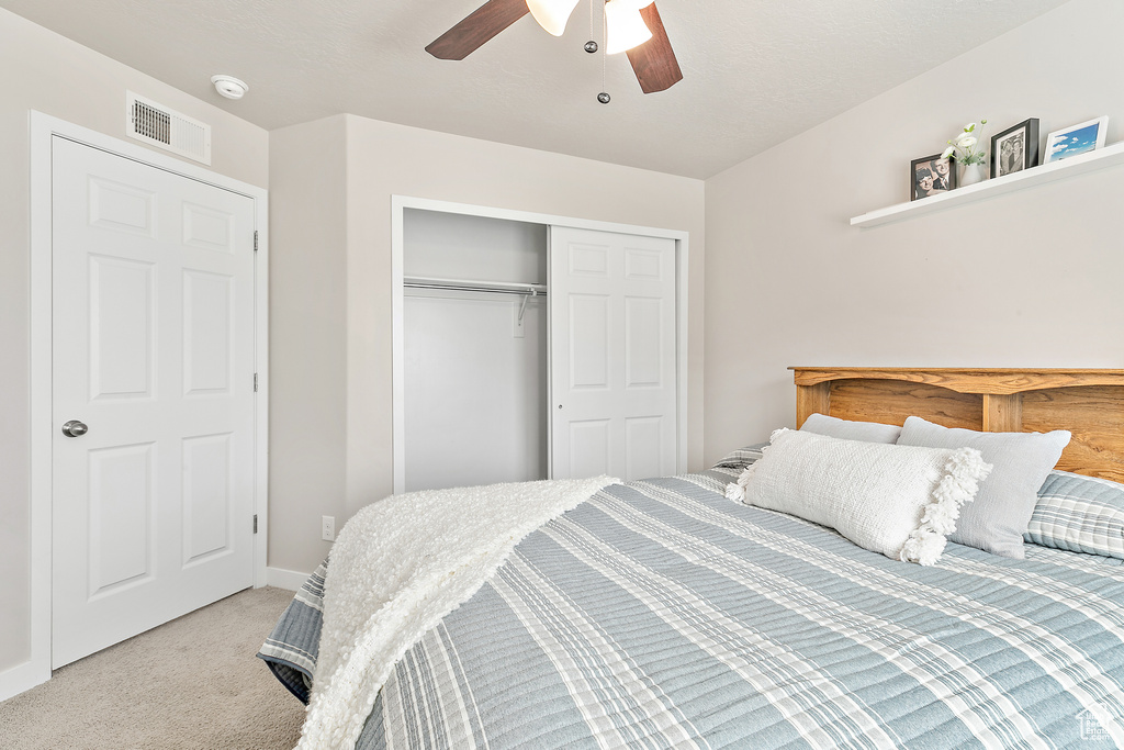 Bedroom with carpet, a closet, ceiling fan, and baseboards