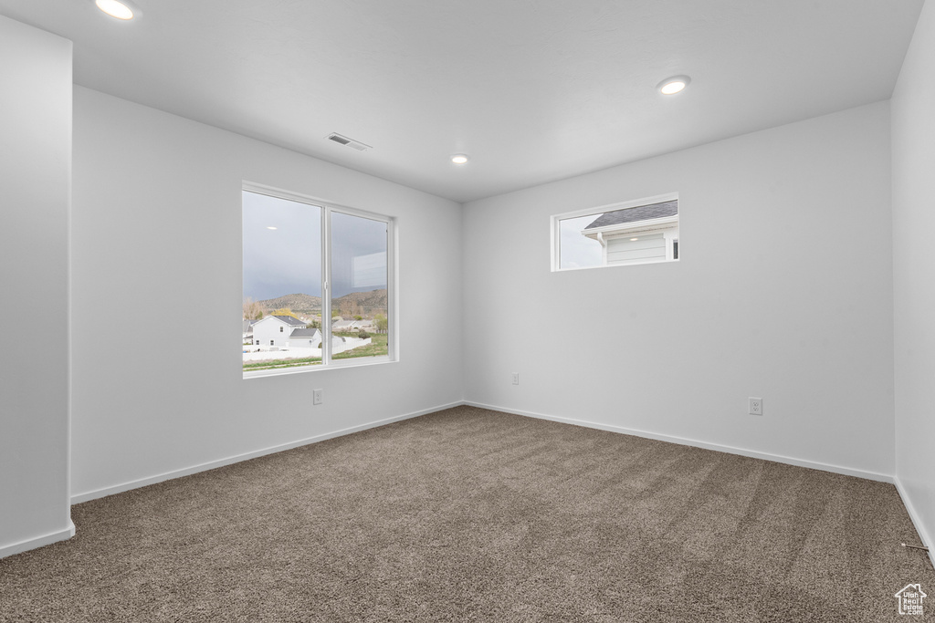 Spare room with carpet floors, recessed lighting, and baseboards