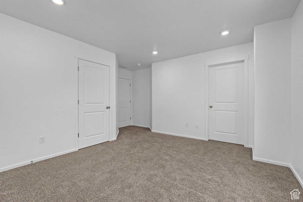 Unfurnished bedroom with carpet, recessed lighting, and baseboards