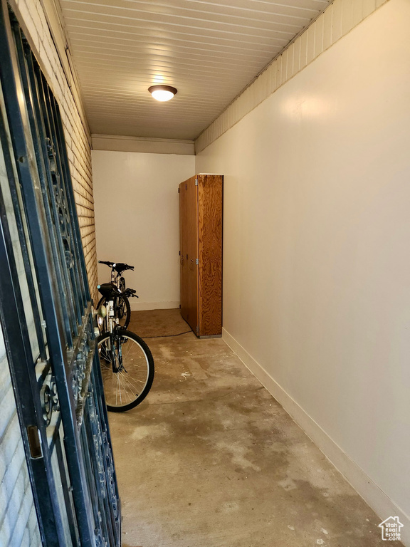 Hall with concrete floors and baseboards
