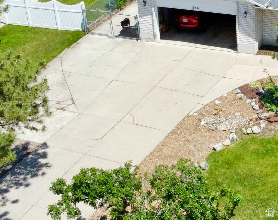 Garage featuring a gate and concrete driveway