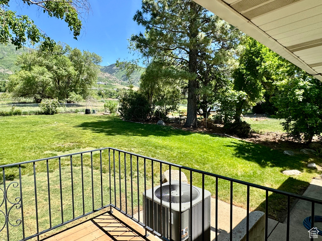 Balcony featuring central AC and a mountain view