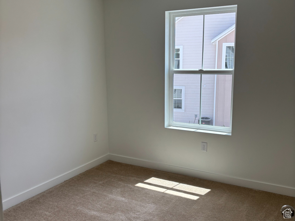 Empty room featuring carpet floors and baseboards